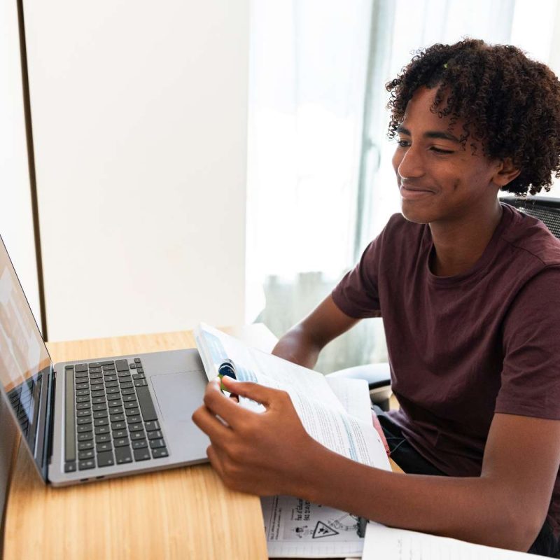 Silver State Youth Academy Class Student on Laptop With Textbook